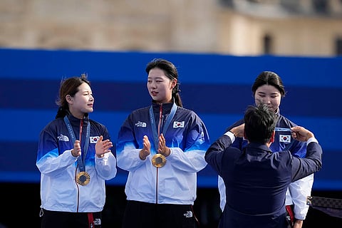 Archery women's team medal ceremony: Gold medal winners, South Korea's Jeon Hun-young, left, Lim Si-hyeon, center, Nam Su-hyeon